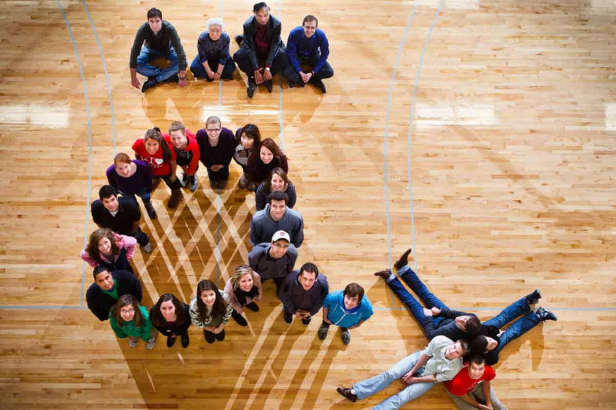 Students and faculty from the Actuarial Science Program pose to represent a common actuarial symbol. 
